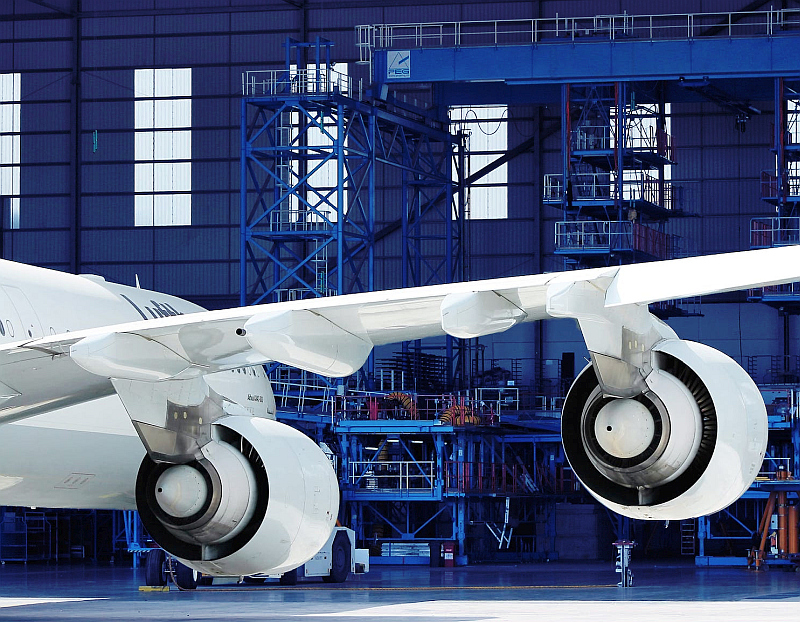 The AS 9100 and AS 9120 AEROSPACE and defence MANAGEMENT STANDARDS - Aeroplane in hangar image.